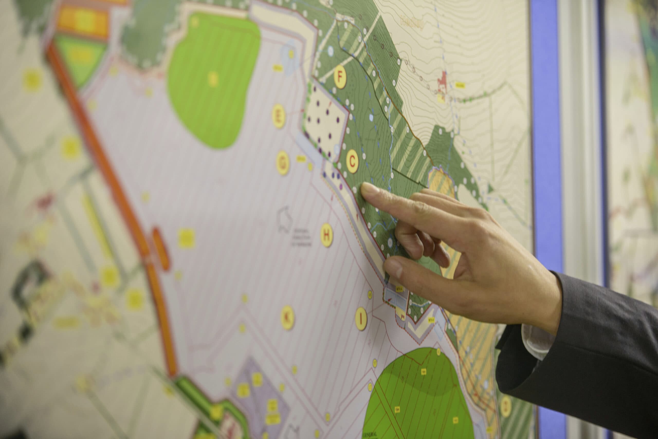 Community member reviewing and pointing to a map of proposed zoning planning.